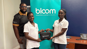 Mr. Damien Prescod of Export Barbados' Bloom program stands beside two students holding the Saturna Imaging System