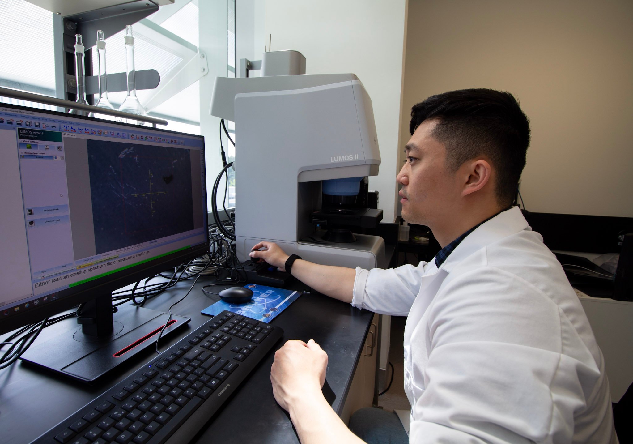 A laboratory scientist analyses microplastics data using fournier transform infrared spectrsocopy